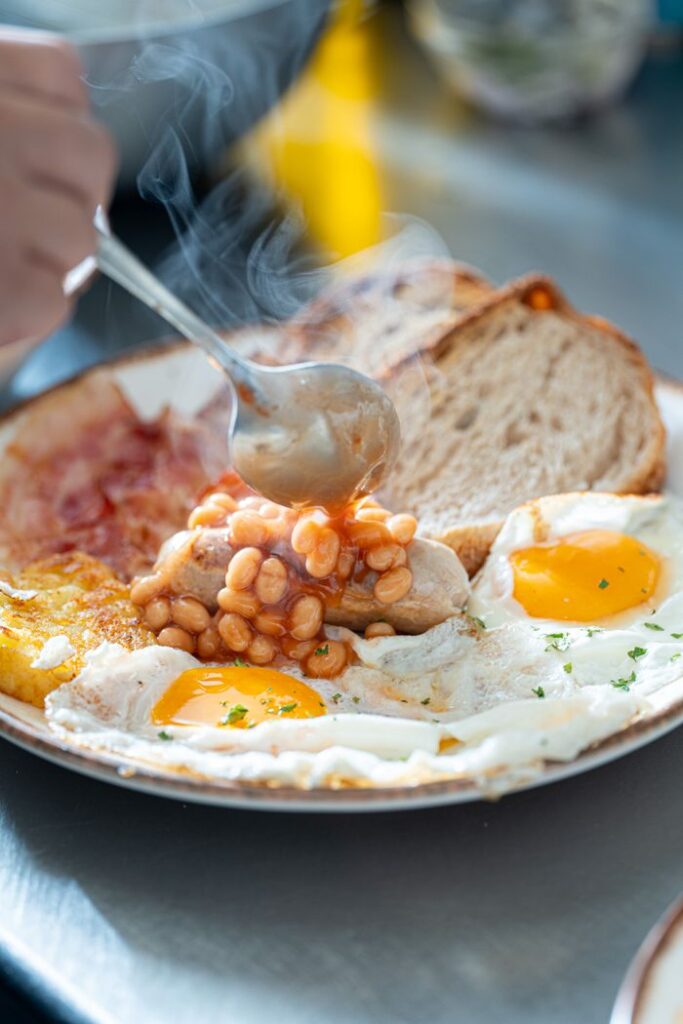 Sizzling English breakfast with eggs, beans, and fresh bread. Perfect start to your day.